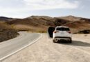 white vehicle parked beside road